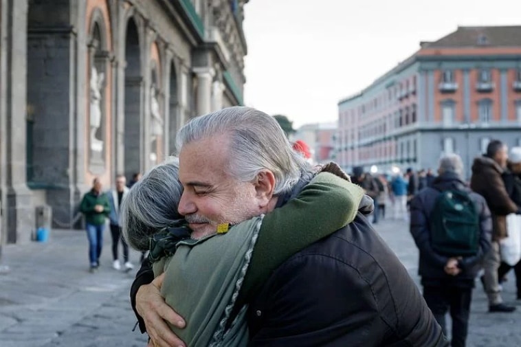 A poem by Tricia McCallum. Apriil 1, 2020. A couple hugging in a public square.