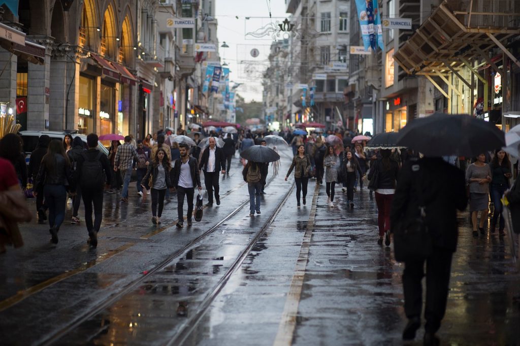 a poem by Tricia McCallum March 26, 2020. city street crowded with pedestrians.