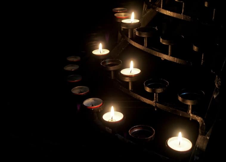 a poem by Tricia McCallum March 26, 2020 - candle votives flickering in rows.